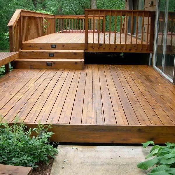 Finished cedar deck with railing and steps, freshly stained