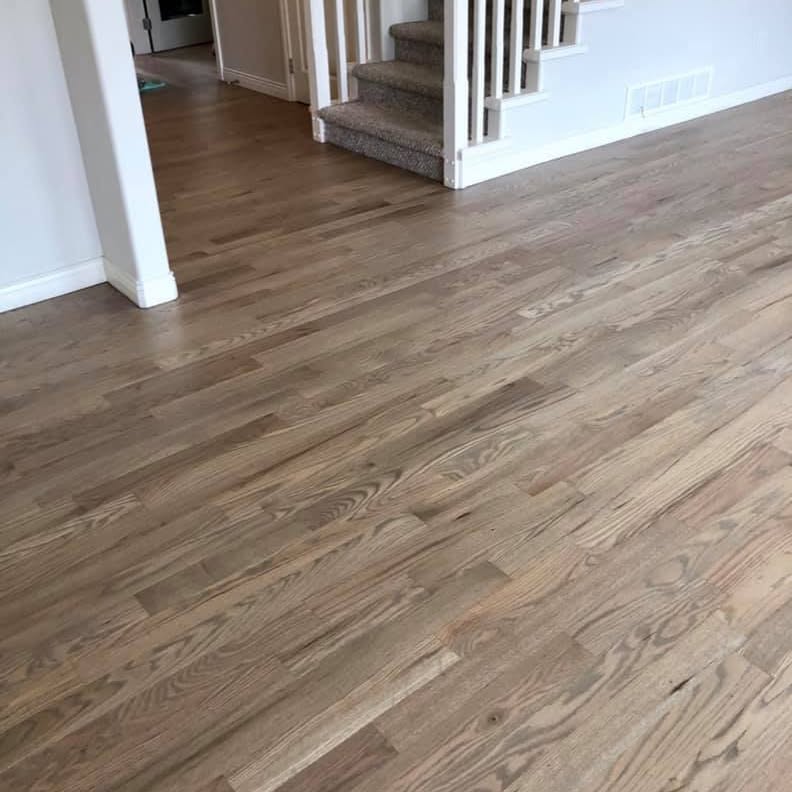 Completed light oak floor running through an open-plan living room